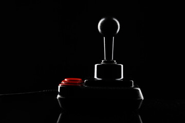 Retro joystick from 8-bit consoles. Game controller isolated on black