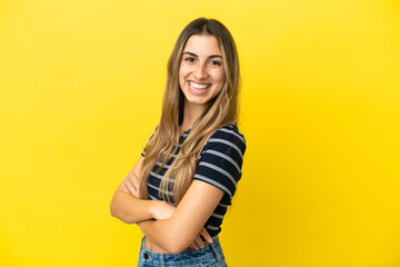 Young caucasian woman isolated on yellow background looking to the side and smiling