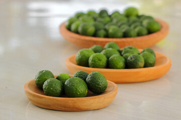 kaffir lime on a coconut wood plate