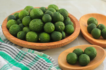 kaffir lime on a coconut wood plate