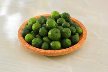 kaffir lime on a coconut wood plate