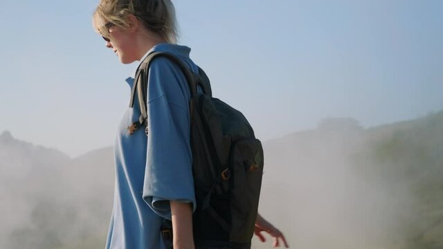 backpacking in highlands, teen girl is exploring top of mountain