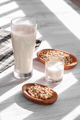 soy milk and soybeans on a wooden table