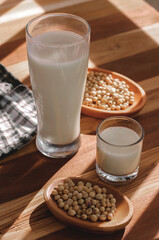 soy milk and soybeans on a wooden table