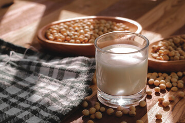 soy milk and soybeans on a wooden table