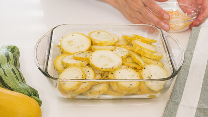 Zucchini slices with garlic seasoning and black pepper. Low-carbs easy cheesy zucchini bake recipe. Zucchini slices close up