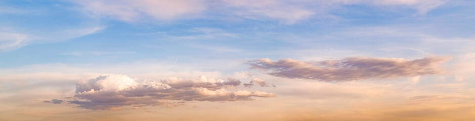 Panorama during sunset over forest with pastel colors sky and colorful clouds