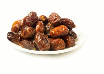 dead dates on a white plate. isolated on white.