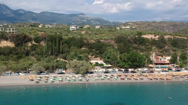 Aerial view over Santova coastal area in Messinia, Greece. Summer scenery with beautiful seaside bars and tourists in Santova near Kalamata city, Greece