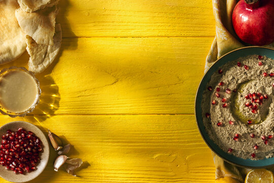 Baba ganoush or mutabal, Middle Eastern eggplant dip sauce garnished with pomegranate seeds, with various ingredients