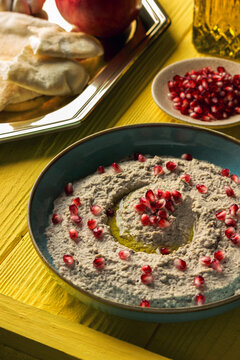 Baba ganoush or mutabal, Middle Eastern eggplant dip sauce garnished with pomegranate seeds, with various ingredients