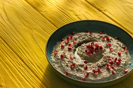 Baba ganoush or mutabal, Middle Eastern eggplant dip sauce garnished with pomegranate seeds