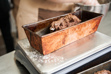Fresh dough at the tank standing at the scales before the weighing