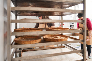 Cake shapes standing at the tray at the trolley at confectionery