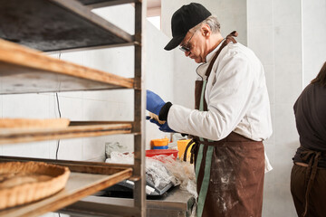 Fresh pies on shelf in bakery preparing to the sailing