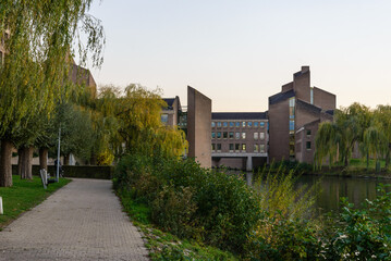 Outdoor scenery view on promenade riverside of Meuse river and Government of Limburg
 during sunset time in Maastricht, Netherlands.  