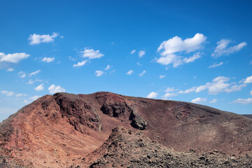 Mount Etna in Sicily near Catania, Tallest active Europe volcano in Italy. Red and purple lava fields around one of the craters.