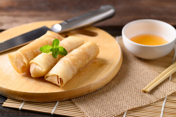 Asian deep fried spring roll stuffed with tofu and glass noodles eating with chili sauce