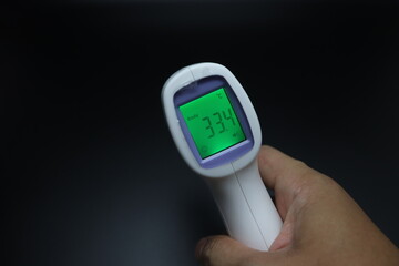 infrared thermometer in hand