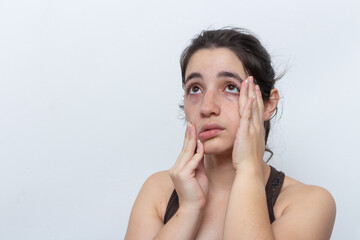 Brown tank top woman on white background with hair tied sweaty and tired