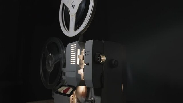 Old 8 mm projector showing film, 4k