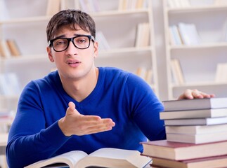 Male student preparing for exams in college library