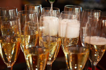 champagne being poured into glasses with bubbly foam