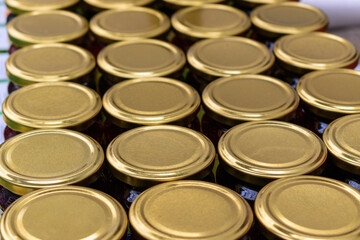 Rows of glass jars with metal lids. Canned food concept. Selective focus.