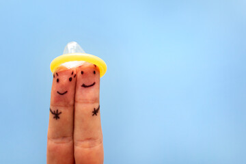 Fingers under condom. Safe sex concept. prevention against sexually transmitted diseases, AIDS.