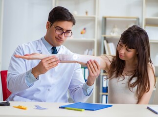 Doctor checking patients joint flexibility with gonimeter