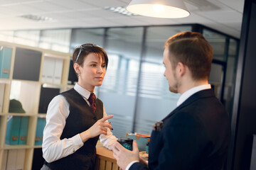 Business people working together sitting at the table against a background of the office. 