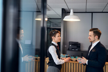 Business people working together sitting at the table against a background of the office. 