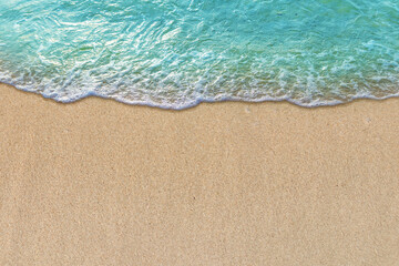 Summer with turquoise wave in tropical beach. Soft waves with foam of blue ocean on the sandy beach.