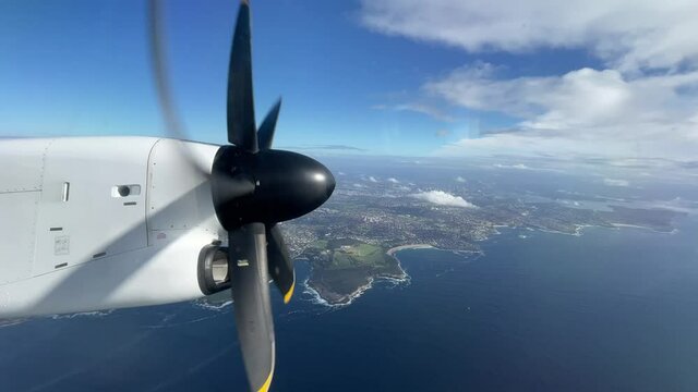 Turbo propeller flight view from passenger window.