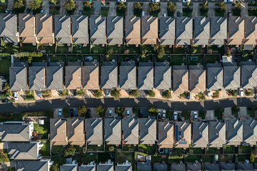 Aerial view of streets, driveways, houses and backyards tightly packed in rows, Sydney, Australia.