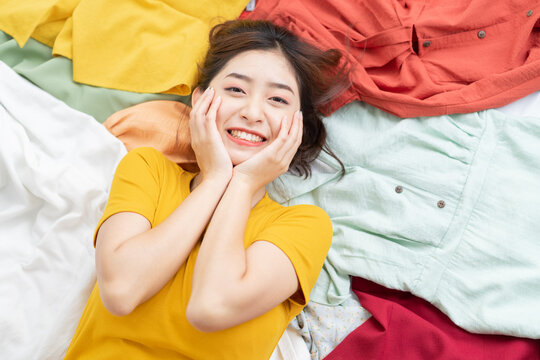 Asian girl stuck in her mess of clothes
