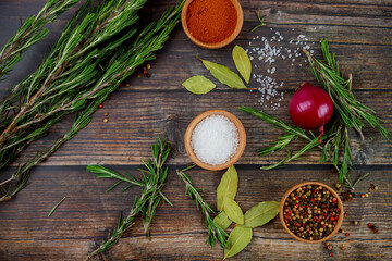 Spices and herbs on rustic wooden table.