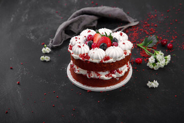 Obraz na płótnie Canvas Delicious homemade red velvet cake with meringue and mascarpone cream on black background.