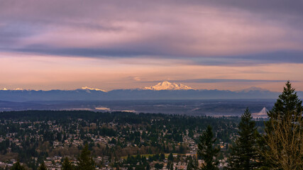 Dusk view across valley to roseate alpine mountain