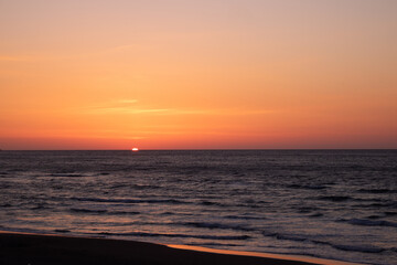 Beautiful sunset on the sea and many birds
