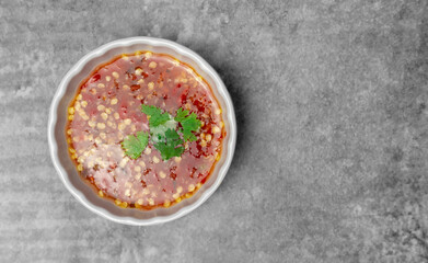 Top view Thai hot and spicy sauce for seafood on the gray concrete table.