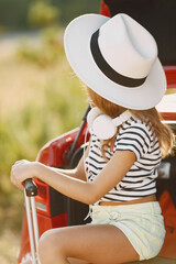 Child sitting in a car trunk