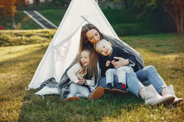 Mother with children playing in a summer park