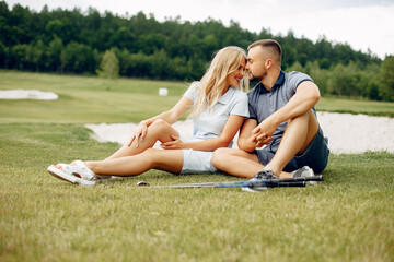 Beautiful couple playing golf on a golf course