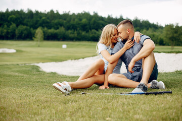 Beautiful couple playing golf on a golf course