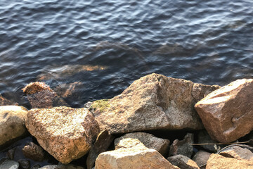 View of the blue lake from the rocky shore