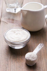 White protein powder in bowl and scoop