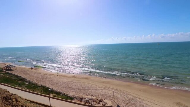 A view from above of the sea on the cliff beach in Tel Aviv, on a warm and pleasant day at the end of winter