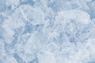 Ice pieces texture light background. Crushed ice blue-toned pattern.