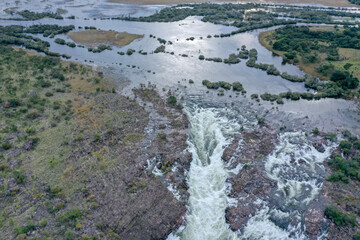 Aerial view of flooded Zambezi River with white water rapids in foreground.